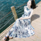 Blue-and-white tie-dye style sleeveless maxi dress with gathered skirt and sleeveless cut
