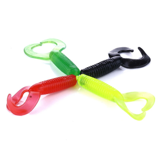 Assorted double-tailed soft fishing lures in red, green, and black tones.