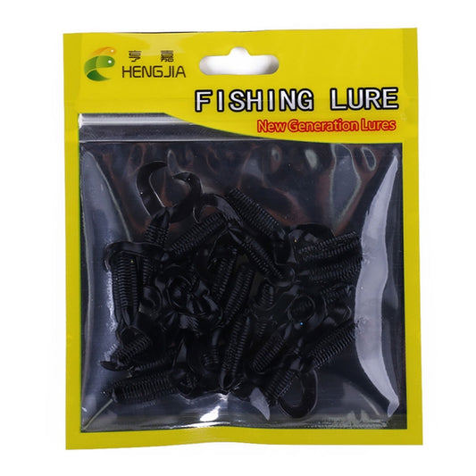 Black double-tailed soft fishing lures in sealed blister pack.