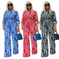 Women's striped off-shoulder jumpsuit in blue, red, and black with wide legs