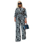 Women's black-and-white striped off-shoulder long-sleeve jumpsuit with wide legs